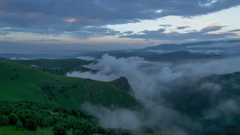 Low clouds in the mountains. Aerial view of low fog in mountainous area Stock Footage 241185981
