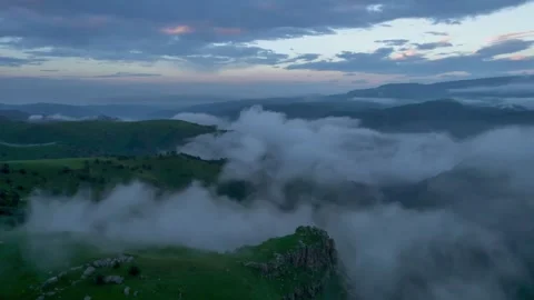 Low clouds in the mountains. Aerial view of low fog in mountainous area Stock Footage 241186050