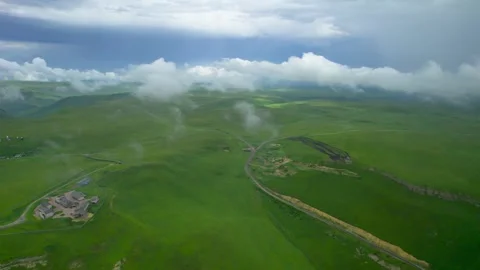 Low clouds in the mountains. Aerial view of low fog in mountainous area Video stock 250965638