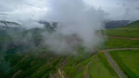 Low clouds in the mountains. Aerial view of low fog in mountainous area Stock Footage 250997497