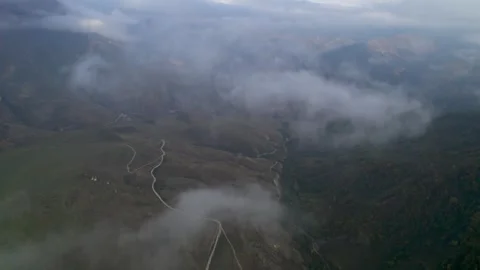 Low clouds in the mountains. Aerial view of low fog in mountainous area Stock Footage 263439546
