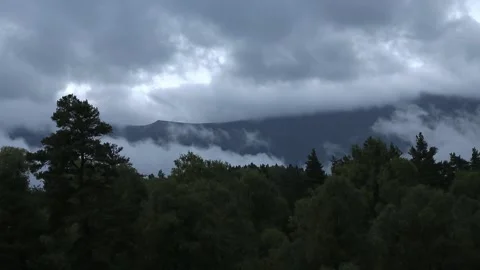 Low clouds in the mountains. Fog movement on high cliffs. Stock Footage 158458490