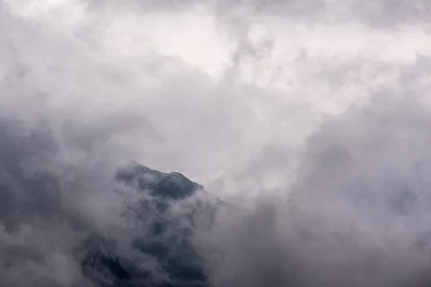 Low clouds on mountains, peak covered by fog and clouds Stock Photos