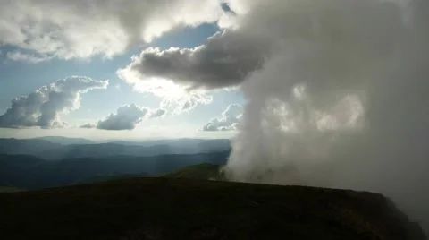 Low clouds move to the side of the sunlit green mountains is not easy Stock Footage 40705378