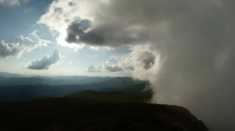 Low clouds move to the side of the sunlit green mountains is not easy Stock Footage 40705397