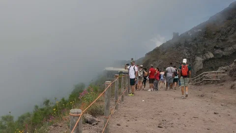 Low clouds moving on mountain ridge with people walking on a hiking trail Stock Footage 113260744