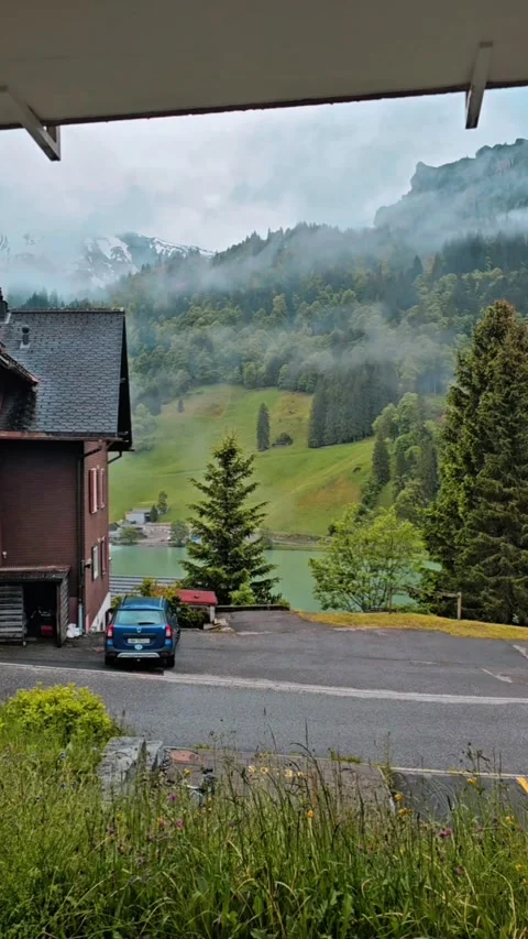 Low Clouds Moving Through Alpine Valley in Engelberg Stock Footage 341406967