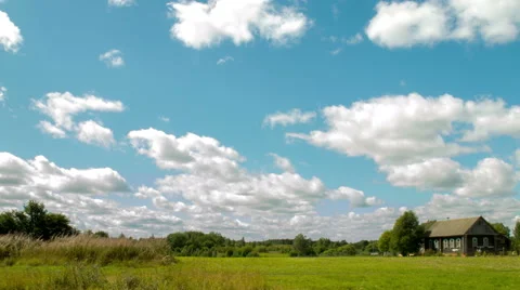 Low clouds over the field and single house in the village 5K Stock Footage 53613894