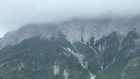 Low clouds over a forested alpine mountain ridge Stock Footage 345168161