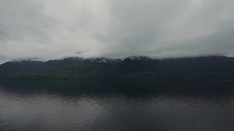 Low clouds over forested mountains and dark channel in Alaska Stock-Footage 347823657