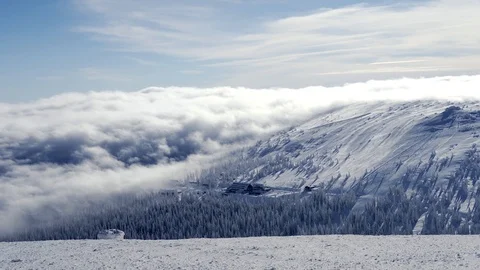 The low clouds over high mountains at winter day.  Stock Footage 102882589