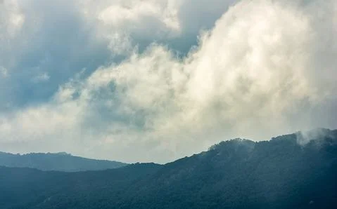 Low clouds over valley, view from the mountains. Low clouds. Stock Photos