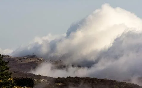 Low clouds over valley, view from the mountains. Low clouds. Stock Photos