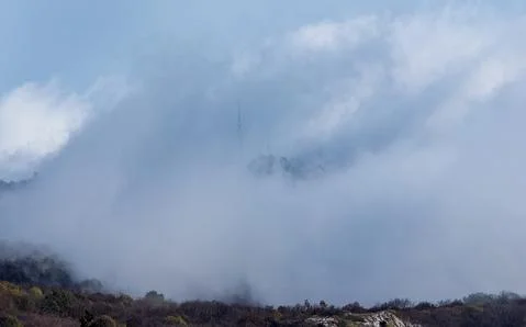 Low clouds over valley, view from the mountains. Low clouds. Stock Photos