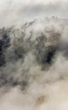Low clouds over valley, view from the mountains. Low clouds. Stock Photos