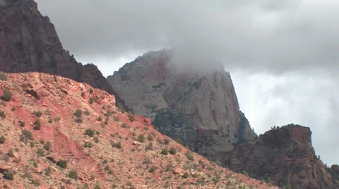 Low clouds pass by sandstone mountains in Zion National Park after a brief rain 스톡 동영상 55732794