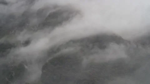 Low Clouds passing a mountain side Stock Footage 50481213