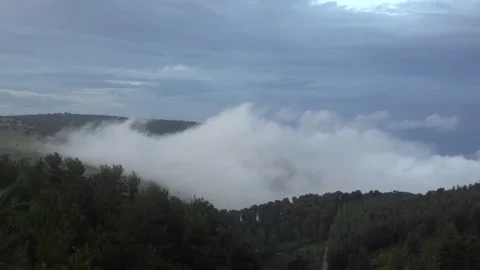 Low Clouds Rolling Over Forest Hills Under Dramatic Sky Stock Footage 332058639