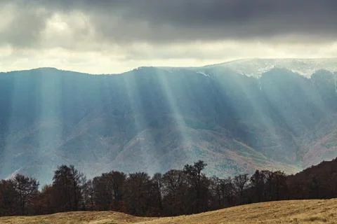 Low clouds with sun rays in the mountains. 스톡 사진