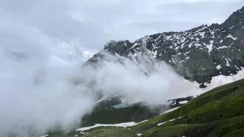 Low clouds sweep across snow-covered Chaukhi slopes Stock Footage 340387963