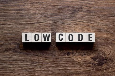 Low code - word concept on building blocks, text Stock Photos