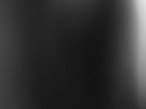 Low contrast grayscale gradient across a smooth surface with soft light on th Foto stock