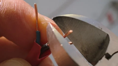 Low-current copper wires are cut with wire cutters. Close-up. Video stock 299385354