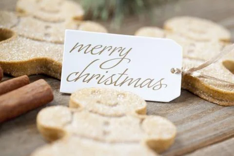 Low depth of field shot of gingerbread men with a merry christmas tag Stock Photos