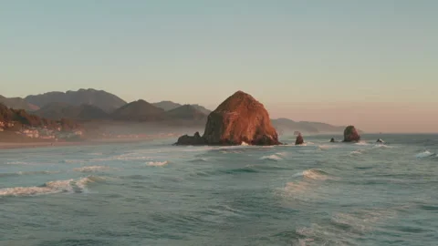 Low dolly forward aerial shot towards Haystack rock Oregon Stock Footage 250251567