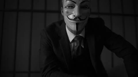 Low dolly shot of Anonymous hacker  in prison (B/W Version) Stock Footage 60580012