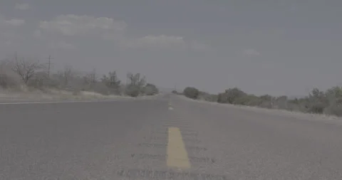 Low Dolly Shot of an Empty Desert Road Through Rural Texas Stock Footage 246459532