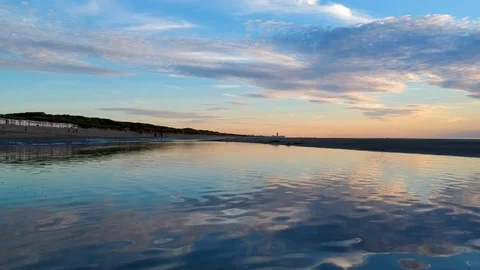 Low down drone shot skimming over beach puddle 2 Stock Footage 122449535