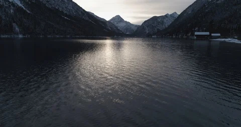 Low down shot above Lake Plansee, panning up to show view Stock Footage 102451390