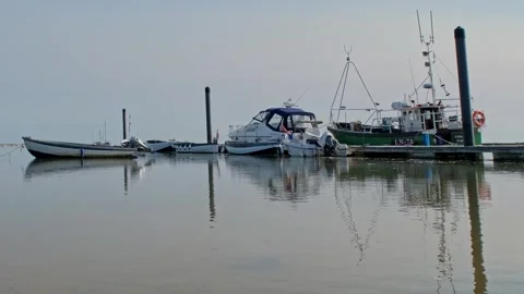 Low down view across Wells Harbour, Norfolk Coast. Pull back shot. Video stock 310466682
