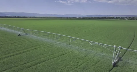 Low Drone Aerial Cinematic Flying Over Farming Equipment Clouds Passing Fast Stock Footage 247675452
