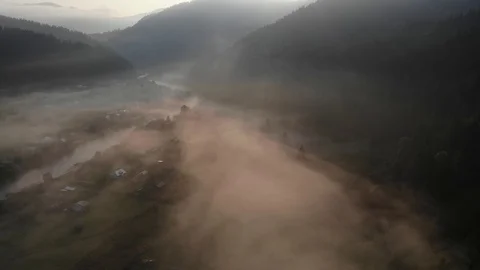 Low drone altitude flight over fresh fast mountain river with village at sunny s Stock Footage 117464836