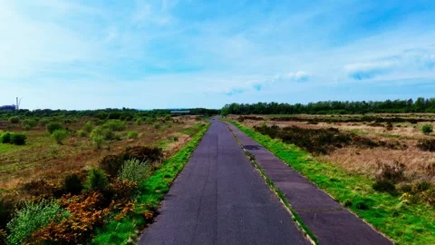 Low Drone Flight Along Isolated Road Through Remote Coastal Moorland Video stock 336847308