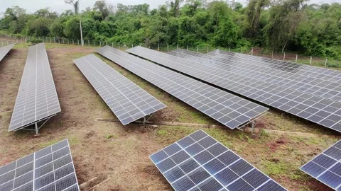 Low Drone Flight Close to Solar Panels Showing Detailed Rows on Cloudy Day Stock Footage 321568647