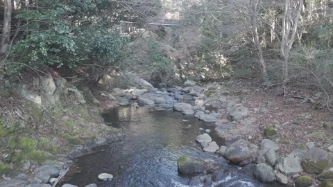 Low Drone Flight Down Narrow Rocky Mountain Stream – 4K Nature Stock Footage 325411290