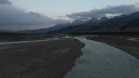 Low drone flight over braided river channels at dusk, Kyrgyzstan Video stock 347241117
