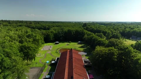 Low Drone Flight Over Building with Orange Roof in the Netherlands Stock Footage 317401268