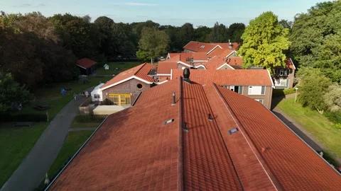 Low Drone Flight Over Building with Orange Roof in the Netherlands 動画素材 317847652