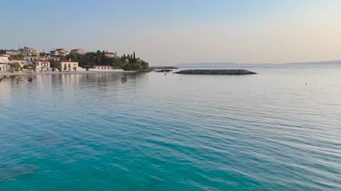 Low Drone Flight Over Calm Greek Bay and Coastal Village Stock-Footage 334632052