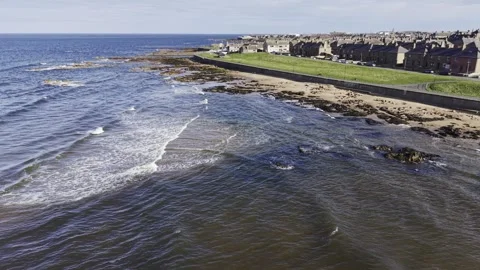 Low Drone Flight Over Coastal Water Near Town and Shoreline Video stock 333784435