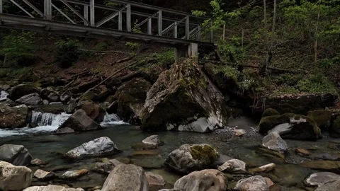 Low Drone Flight Over Crystal Clear Mountain River in Engelberg Stock Footage 336814967