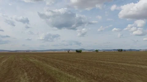 Low Drone Flight Over Harvested Field Under Dramatic Clouds Stock Footage 345311458