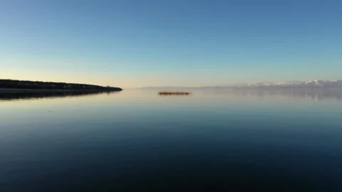 Low Drone Flight Over Lake Sevan With Reflection and Birds at Sunrise Stock Footage 308857992