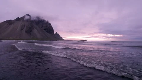 Low Drone Flight Over Ocean Waves in Stokksnes Iceland Epic Purple Sunset Stock Footage 258494416