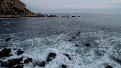Low drone flight over a rocky ocean inlet Vídeo Stock 98382593