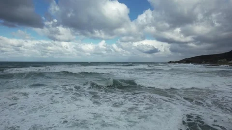 Low drone flight over rough sea toward the coast, Crete Stock Footage 346723835